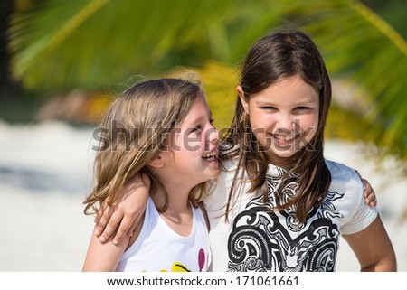 Happy little girls enjoy summer day at the beach