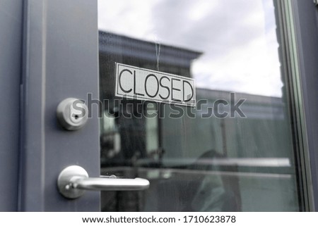 small business, pandemic and service concept - glass door of closed shop or office