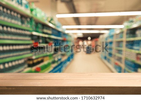 Supermarket background, Counter over blur grocery background, Wooden desk, table, shelf and blur woman shopping at supermarket, Wood counter for grocery store retail product display backdrop, template