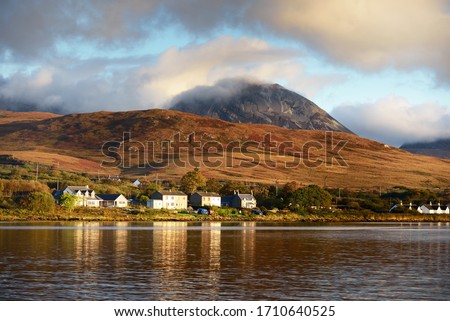 Panoramic view of the valley near the Paps of Jura under the colorful stormy sunset sky. Traditional country houses close-up. Dramatic cloudscape. Jura island, Inner Hebrides, Scotland, UK Royalty-Free Stock Photo #1710640525