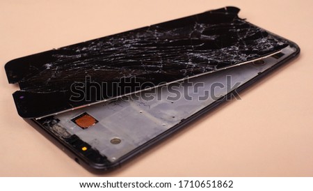 broken phone touchscreen, smartphone on a beige background.