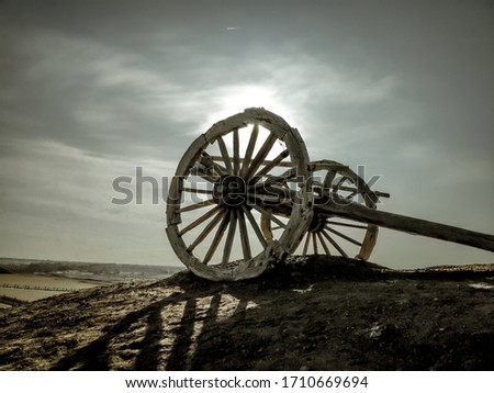 The dry screeching wheels of the horse carriage in the cold lonely desert.