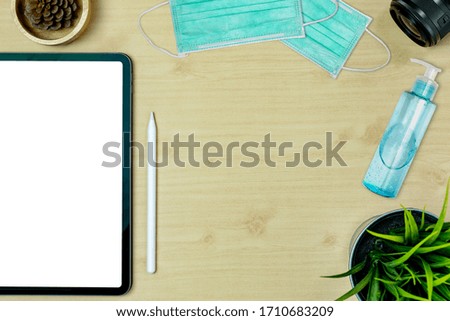 Photographer desk top table wood work space work from home event coronavirus top overhead for develope photo place layout left have tablet gadget mock up isolate and have mask, alcohol gel