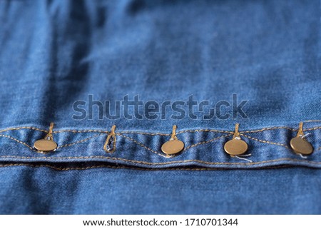 denim fabric with button fly. one button is not fastened. Background for the design