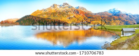 Awesome autumn panorama of Silvaplana lake and Surlej village. Location: Silvaplana, Maloya district, Engadine region, Grisons canton, Switzerland, Europe.