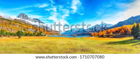 Charming autumn scene in Swiss Alps and views of Sils Lake (Silsersee). Colorful autumn scene of Swiss Alps. Location: Maloya, Engadine region, Grisons canton, Switzerland, Europe.