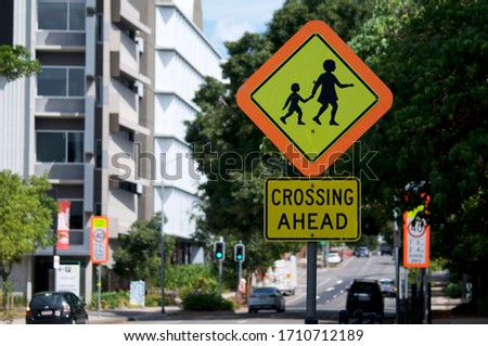 A school children crossing warning sign located in the city of Brisbane, Australia