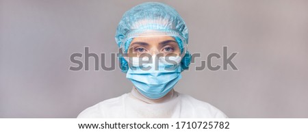 Doctor virologist in medical uniform and goggles, close-up portrait, seriously looking at the camera. widescreen high-quality image. copy space. blank space for text or logo Royalty-Free Stock Photo #1710725782