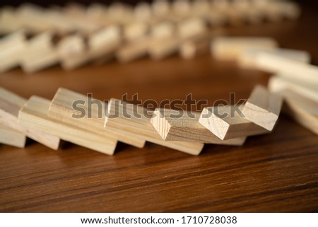 Fell dominoes on wooden table