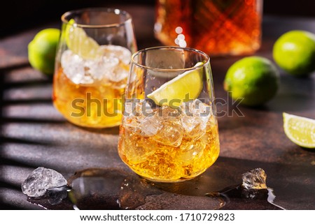 Cuban strong rum with ice and lime, summer concept with a strong shadows, selective focus image