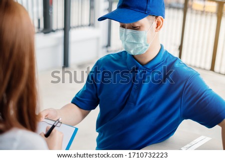 Door to door delivery express sending send a package wearing mask to customer receiver sign checking shipping deliver cargo prevention infection quarantine while the virus is spreading, Coronavirus.