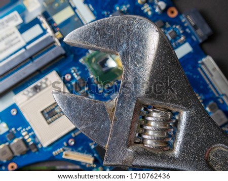 Computer repair concept, wrench on motherboard close up