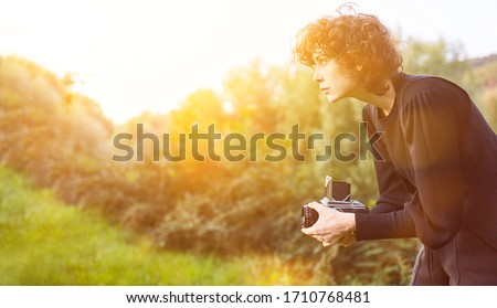 Photographer is photographing with vintage medium format camera in nature