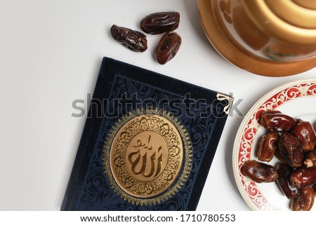 some kind of Al Quran book and some date palm