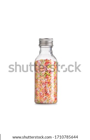 full color topping sprinkle in glass bottle on isolated white background