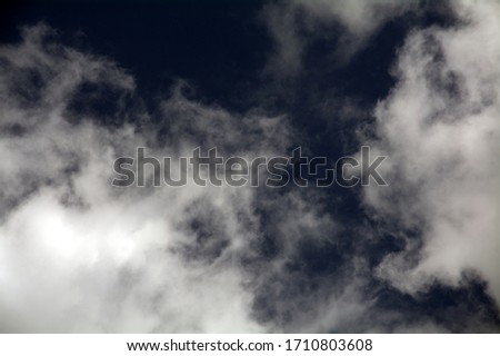 white fluffy clouds on a background of blue sky