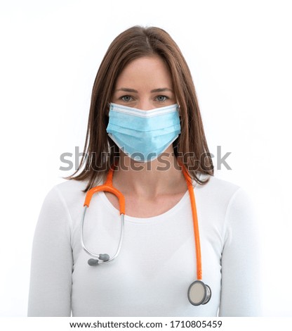 Young european female doctor wearing face mask posing on white background with stethoscope