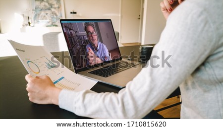 Business partners using laptop for a online meeting on video call. Businesswoman working from home making video call to business partner using laptop. Royalty-Free Stock Photo #1710815620