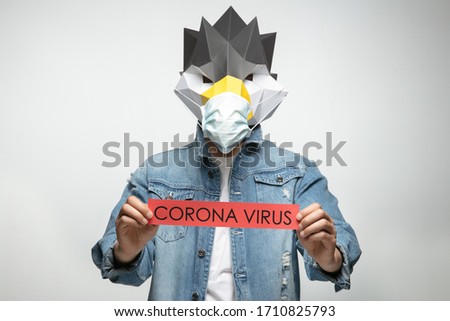young man wearing animal mask and 
surgical mask,With the covid-19 sign.