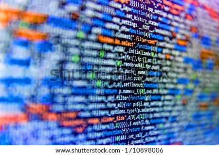 Closeup of Java Script and HTML code. Developer working on source codes on computer at office. Web abstract programming and created virus on laptop screen. Shallow Depth of Field effect