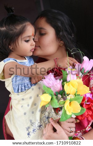 selective focus on a flowers,  2 year old daughter gives flowers to mom on the occasion of Happy mother's day