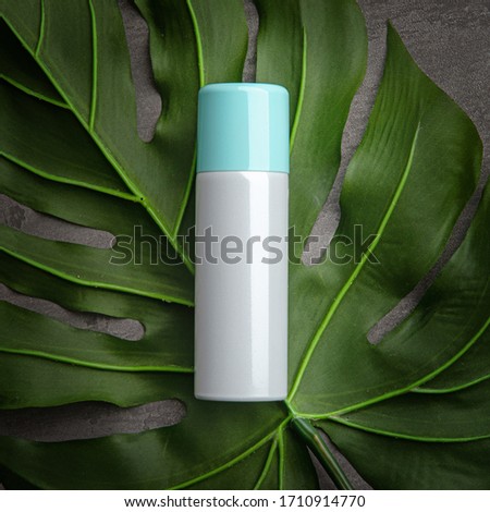 Cosmetic containers on the big leaves Royalty-Free Stock Photo #1710914770
