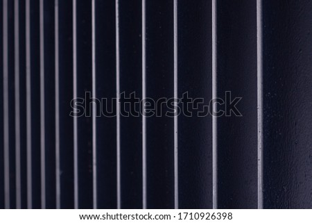 Black metal grate with illuminated sides in perspective
