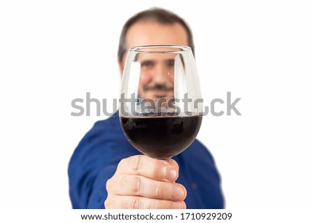 man toasting with a glass of wine on camera