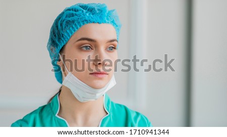 Close-up young female nurse wearing equipment and mask