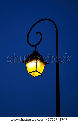 Beautiful vintage wrought iron flashlight in the evening 