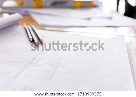 The pencil is placed on the design paper of the engineer.