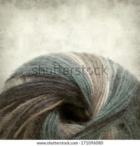 textured old paper background with variegated knitting wool