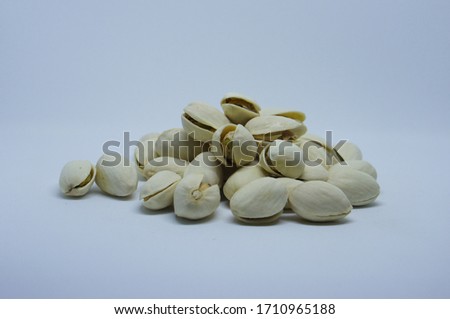 Pic pistachios on white background.