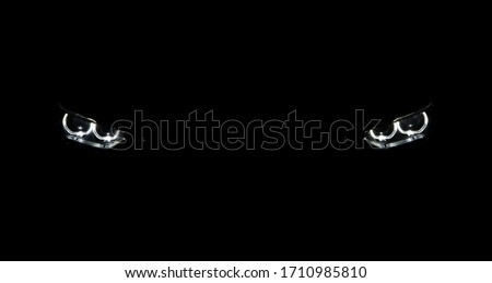The head lights of a luxury sports car in the dark garage Royalty-Free Stock Photo #1710985810