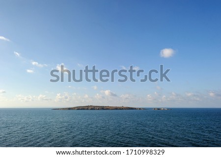 
Island in the black sea against the blue sky. Sozopol, Burgas region, Bulgaria.