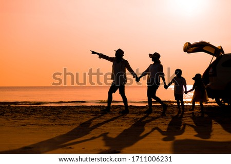 Happy family children walking on the beach at the sunset time.  Concept family and Holiday and travel.
copy space for put text