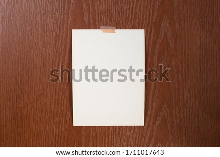 Blank polaroid photo frame with soft shadows and scotch tape isolated on white paper background as template for graphic designers presentations, portfolios etc.white leaves on wooden background