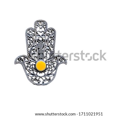 Fatima Hand closeup on a white background with a copyspace. Ancient symbol and traditional modern tourist souvenir of Tunisia