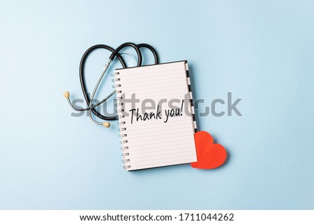 Thank you to doctors, nurses, medical workers. HAPPY NURSES DAY background, banner. International Nurses Day Healthcare and medical concept with notebook, red heart and stethoscope Royalty-Free Stock Photo #1711044262