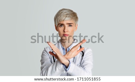 Strict woman doctor shows sign not allowed Royalty-Free Stock Photo #1711051855