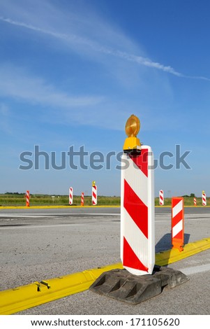 Roadworks, road sign in a highway on reconstruction with blue sky and clouds