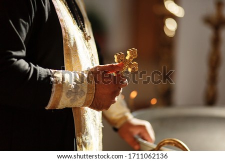 Russian Eastern orthodox church priest holds an orthodox cross in a hand. Close-up photo Royalty-Free Stock Photo #1711062136