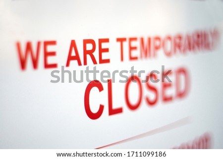 Sign in a shop window: We are temporarily closed. Covid-19 isolation and closed shops.