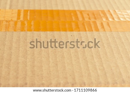 scotch tape stick wrapping on brown carton paper box package of industrial, image used for design background