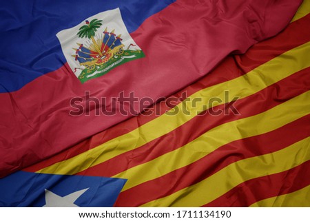 waving colorful flag of catalonia and national flag of haiti. macro
