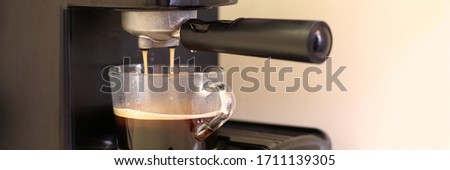 Automatic coffee machine makes natural coffee in glass cup. Business offer vending. Installation office center
