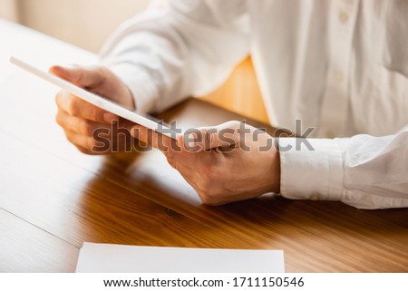 Holding tablet. Close up of caucasian male hands, working in office. Concept of business, finance, job, online shopping or sales. Copyspace for advertising. Education, communication freelance.