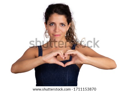 Portrait of young beautiful woman make heart shape with hands in studio. Isolated white background. Love concept.
