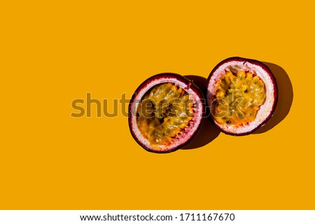 Cut passion fruit on a yellow background. Royalty-Free Stock Photo #1711167670