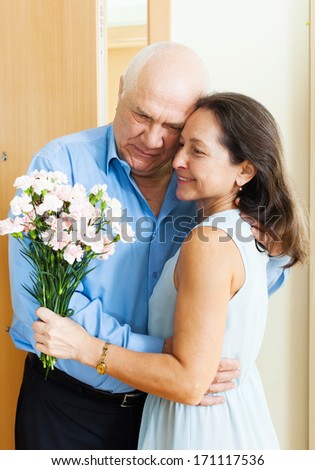 Mature couple greeting in the doorway